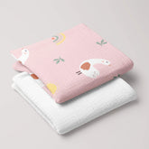 Lady Goose muslin swaddle and white 4-ply muslin baby blanket folded as a matching set